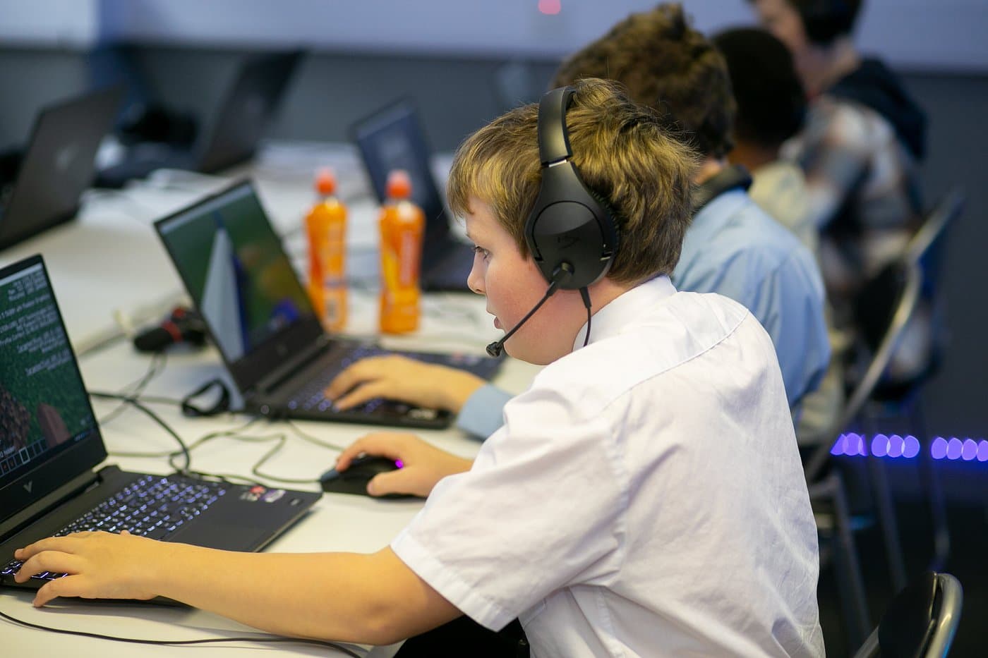 Students working on game projects at a Player Ready coding club session