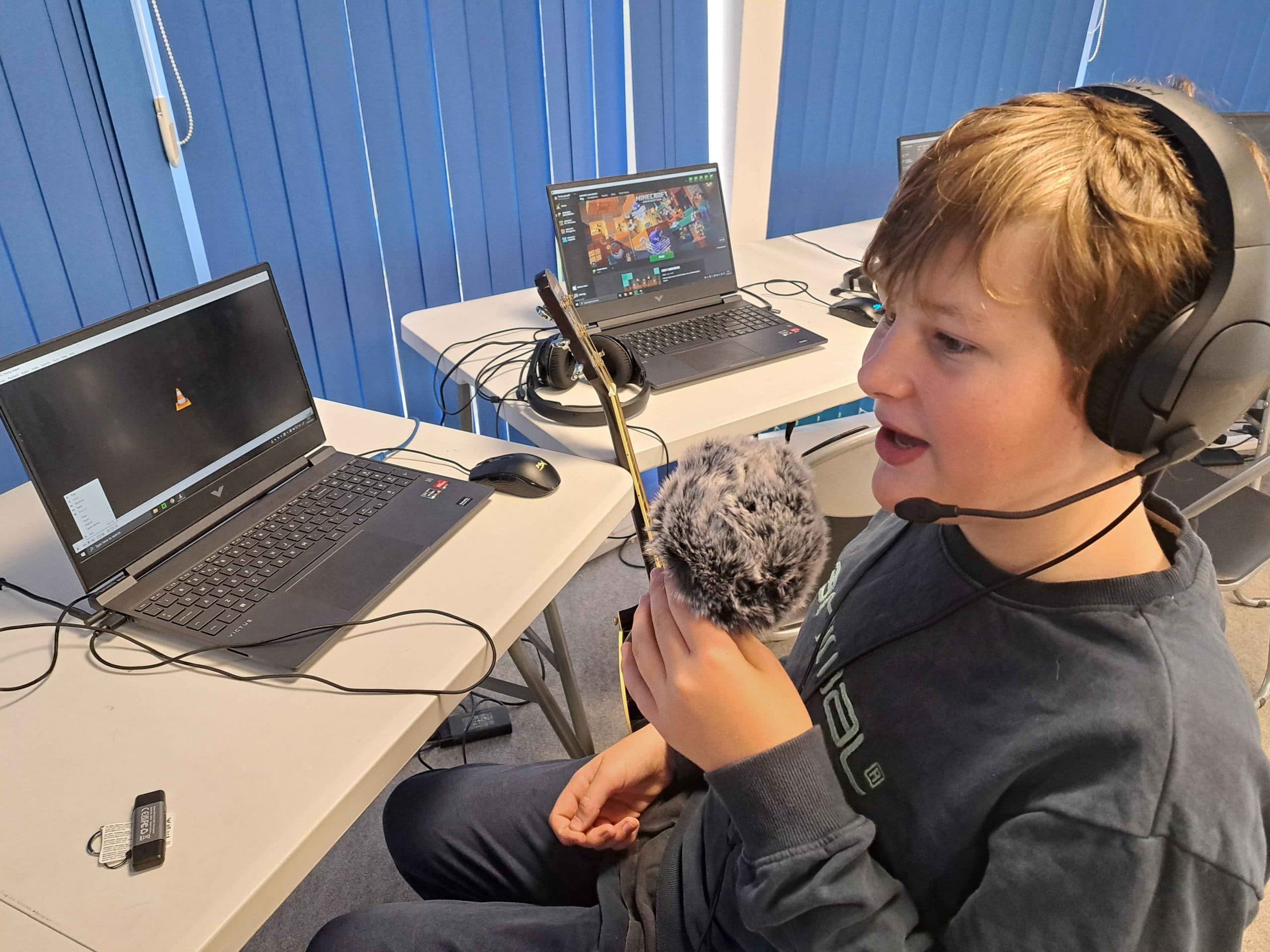A student at Player Ready Truro recording audio with a professional microphone during a mentoring session